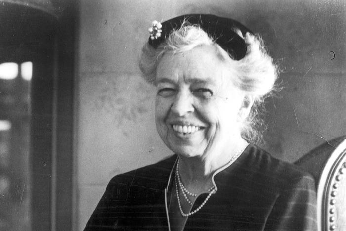 Eleanor Roosevelt smiling and wearing a black hat
